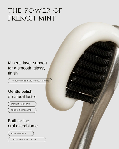 Bastét nano hydroxyapatite toothpaste on a black toothbrush, a gentle polish built for the oral microbiome
