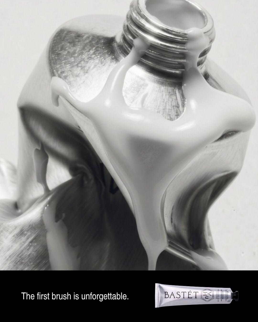 Thick white Bastét toothpaste flowing from an aluminium tube
