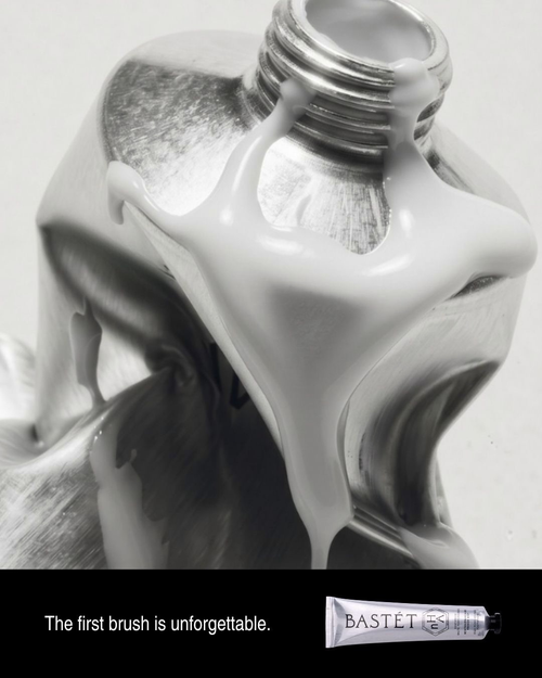 Thick white Bastét toothpaste flowing from an aluminium tube